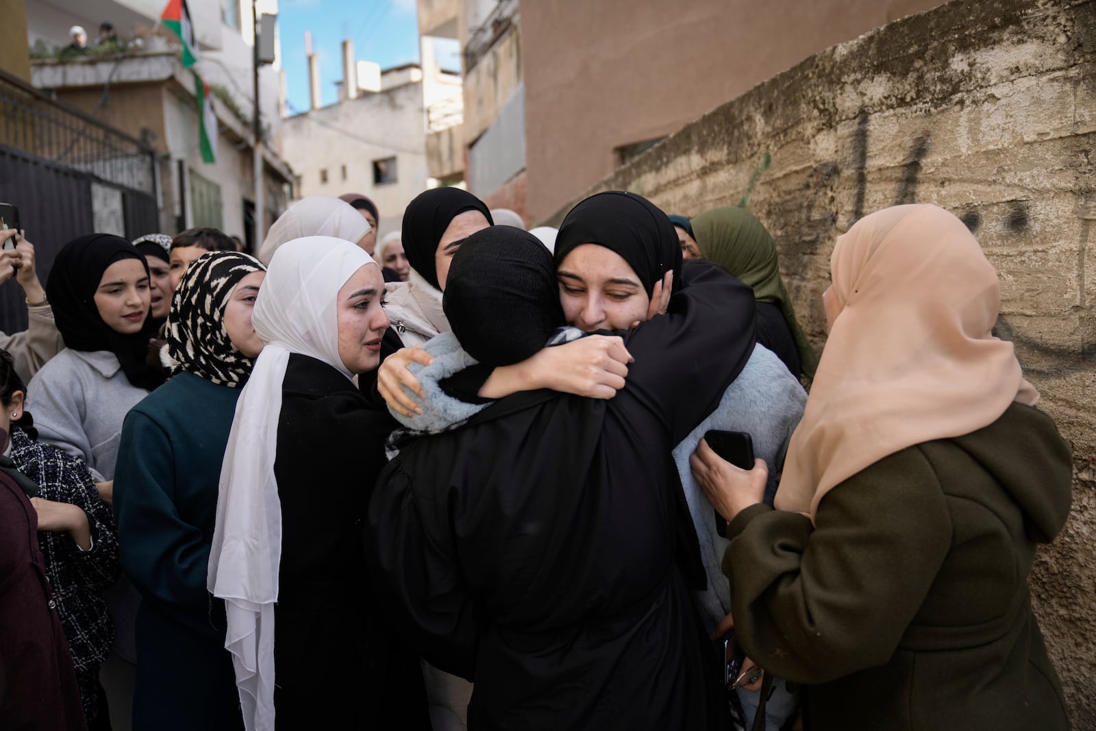 FILE - Dunya Shtayyeh, center, was released from an Israeli prison as part of a ceasefire deal between Israel and Hamas, in the West Bank village of Salem, Jan. 20, 2025. (AP Photo/Majdi Mohammed, File)