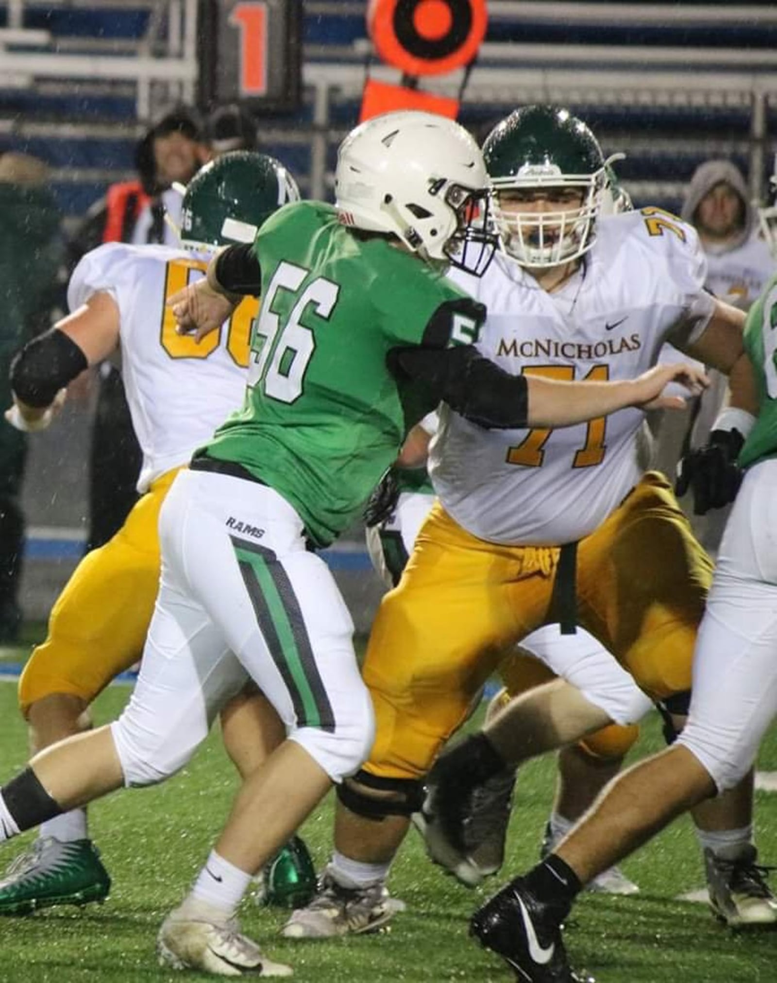 Badin’s Brayden Abner (56) battles Austin Ramey (71) of McNicholas at the line of scrimmage during Friday’s game at Virgil Schwarm Stadium in Hamilton. CONTRIBUTED PHOTO BY TERRI ADAMS