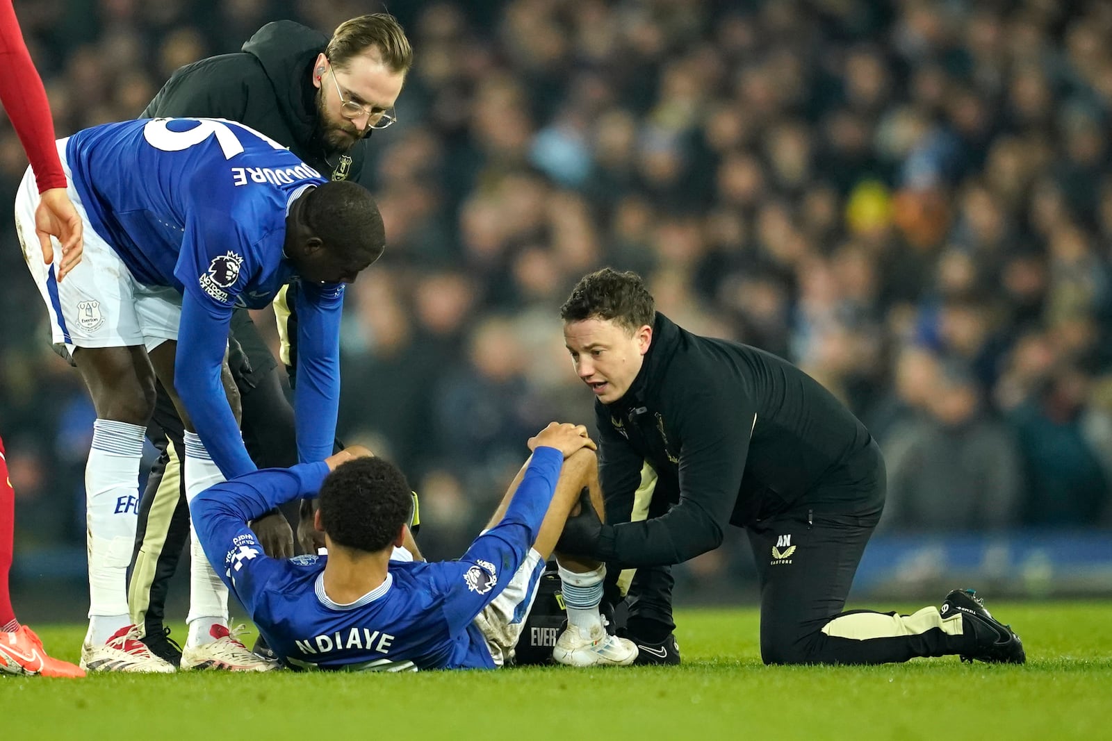 Everton's Iliman Ndiaye receives medical attention during the English Premier League soccer match between Everton and Liverpool, Liverpool, England, Wednesday, Feb.12, 2025. (AP Photo/Dave Thompson)