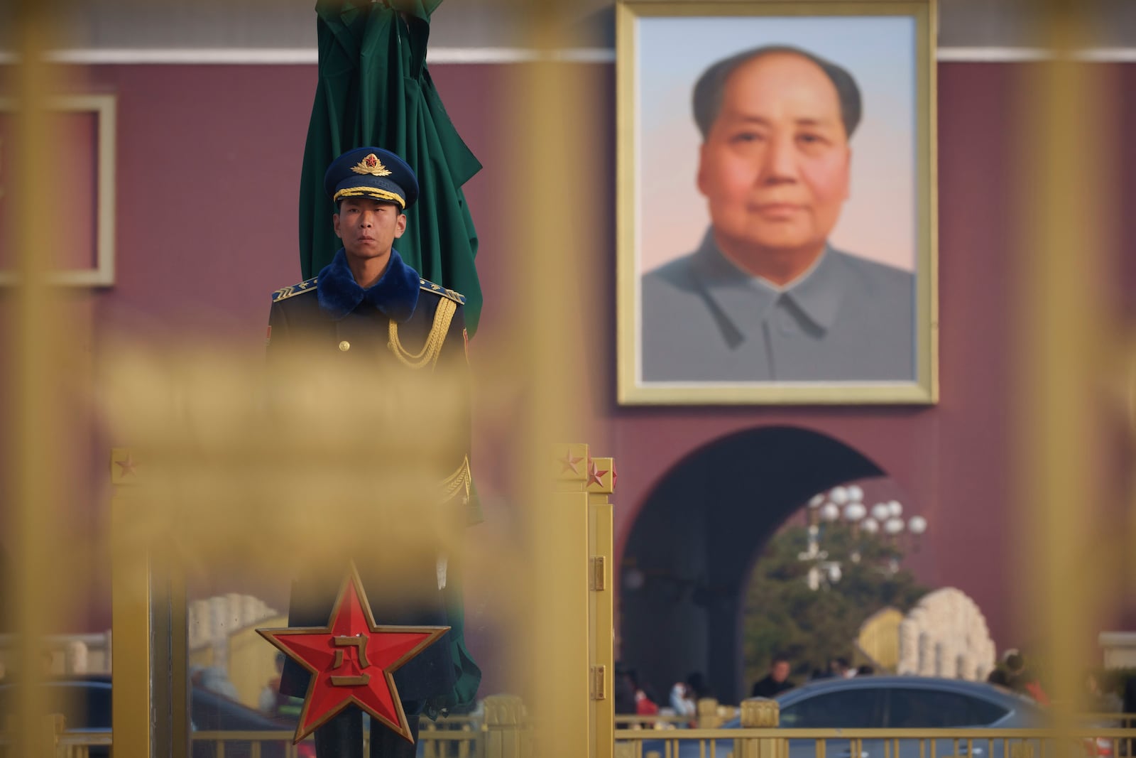 A Chinese paramilitary guard stands in front of a portrait of former Chinese leader Mao Zedong at Tiananmen Square during the opening session of the National People's Congress (NPC) at the Great Hall of the People in Beijing, China, Wednesday, March 5, 2025. (AP Photo/Vincent Thian)