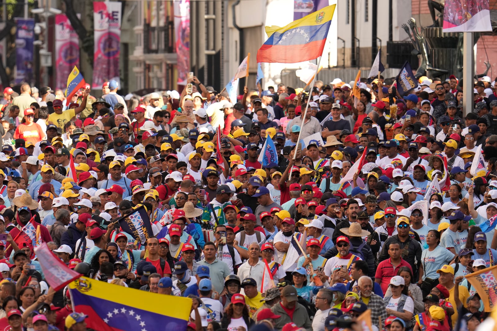 Government supporters listen to Venezuelan President Nicolas Maduro speak at Miraflores presidential palace in Caracas, Venezuela, on his inauguration day for a third term, Jan. 10, 2025. (AP Photo/Matias Delacroix)