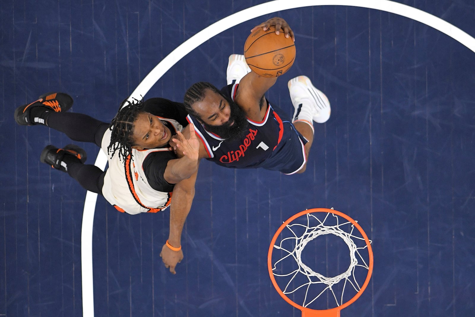 Los Angeles Clippers guard James Harden, right, shoots as Detroit Pistons forward Ausar Thompson defends during the first half of an NBA basketball game Wednesday, March 5, 2025, in Inglewood, Calif. (AP Photo/Mark J. Terrill)