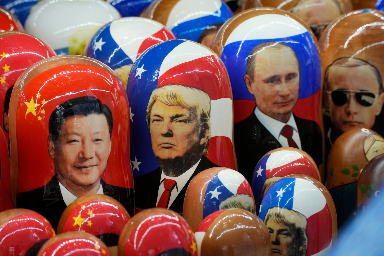 FILE - Traditional Russian wooden dolls called Matryoshka depicting China's President Xi Jinping, U.S. President-elect Donald Trump and Russian President Vladimir Putin are displayed for sale at a souvenir shop in St. Petersburg, Russia on Nov. 21, 2024. (AP Photo/Dmitri Lovetsky, File)