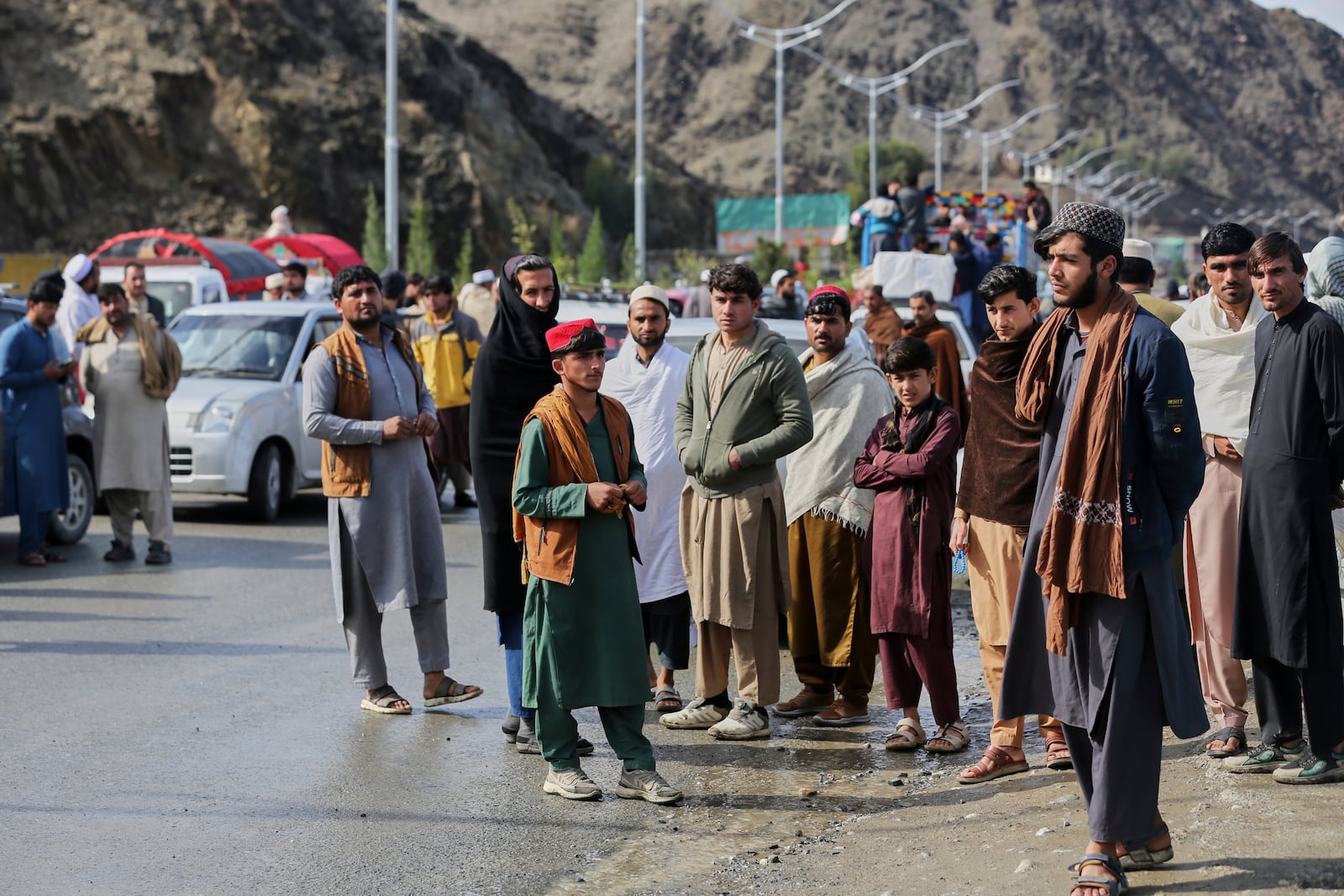 Afghans wait to cross the closed Torkham border with Pakistan, where Pakistani and Afghan forces exchanged fire overnight, in Torkham, Afghanistan, Monday, March 3, 2025.(AP Photo/Shafiullah Kakar)