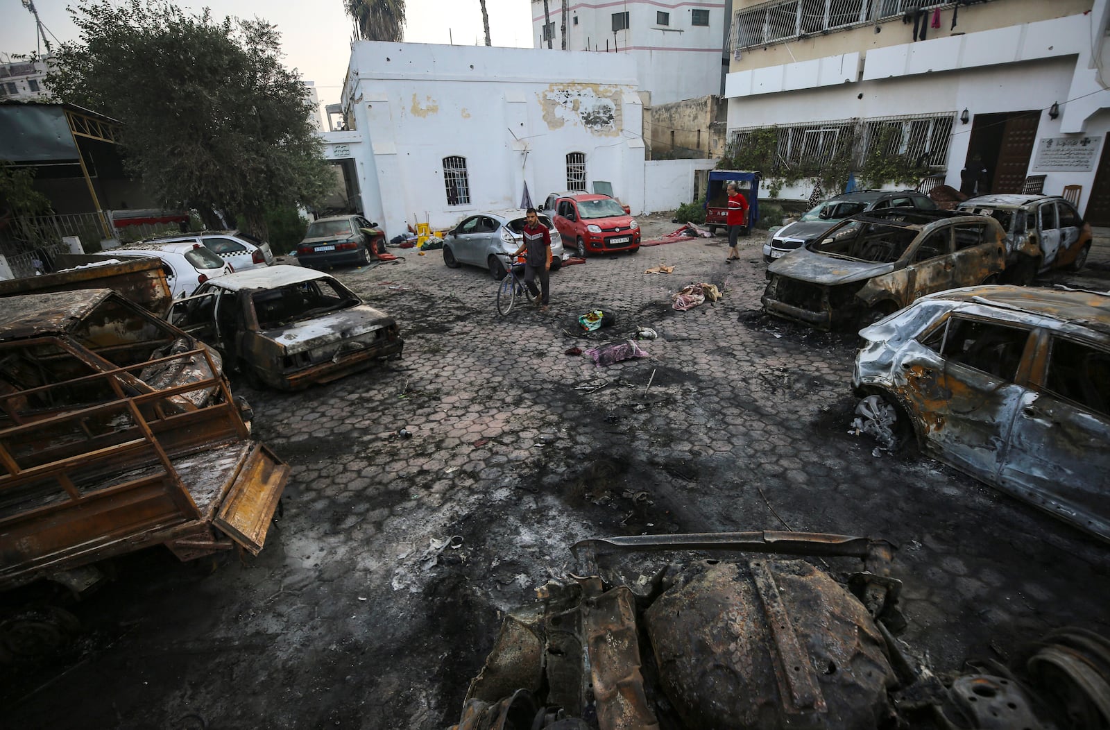 FILE - Men look over the site of a deadly explosion at Al-Ahli Hospital in Gaza City, on Oct. 18, 2023. (AP Photo/Abed Khaled, File)