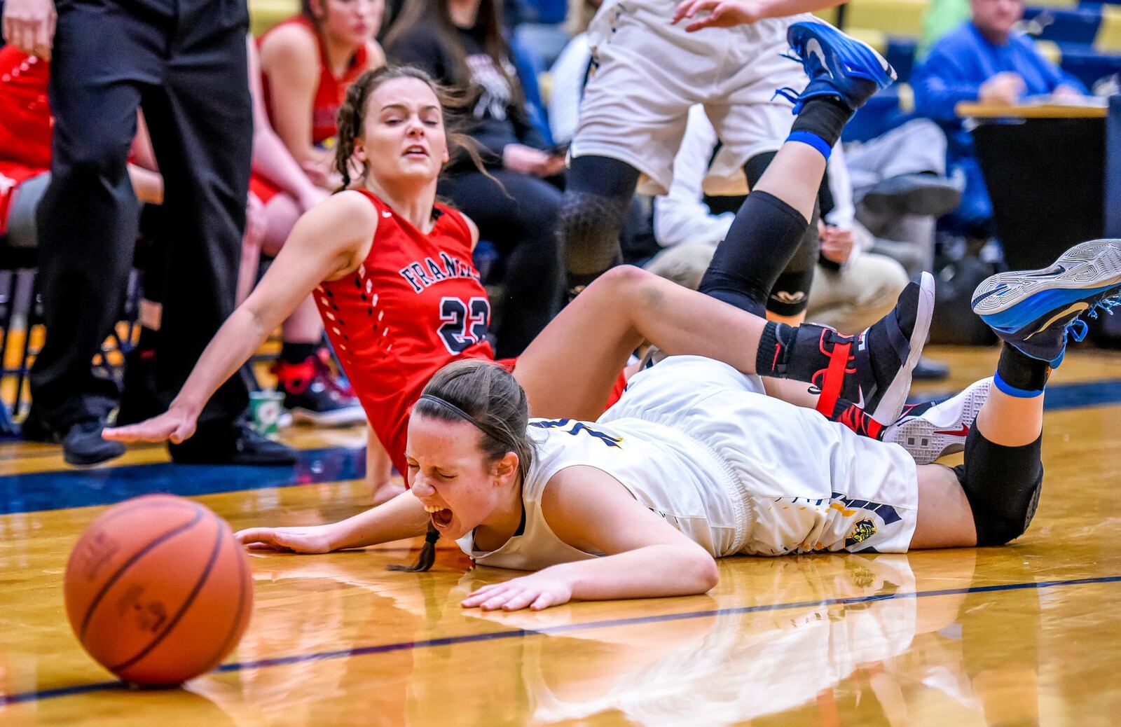 Franklin’s Jessica King (22) and Monroe’s Katie Sloneker fall to the ground as they fight for a ball during their game Dec. 15, 2016. NICK GRAHAM/STAFF