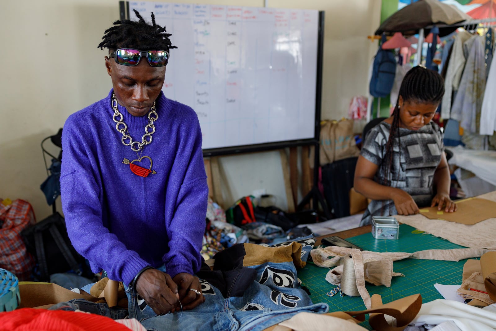 Designers work in the remanufacturing space at the OR Foundation to upcycle textile waste in Accra, Ghana, Thursday, Oct. 24, 2024. (AP Photo/Misper Apawu)