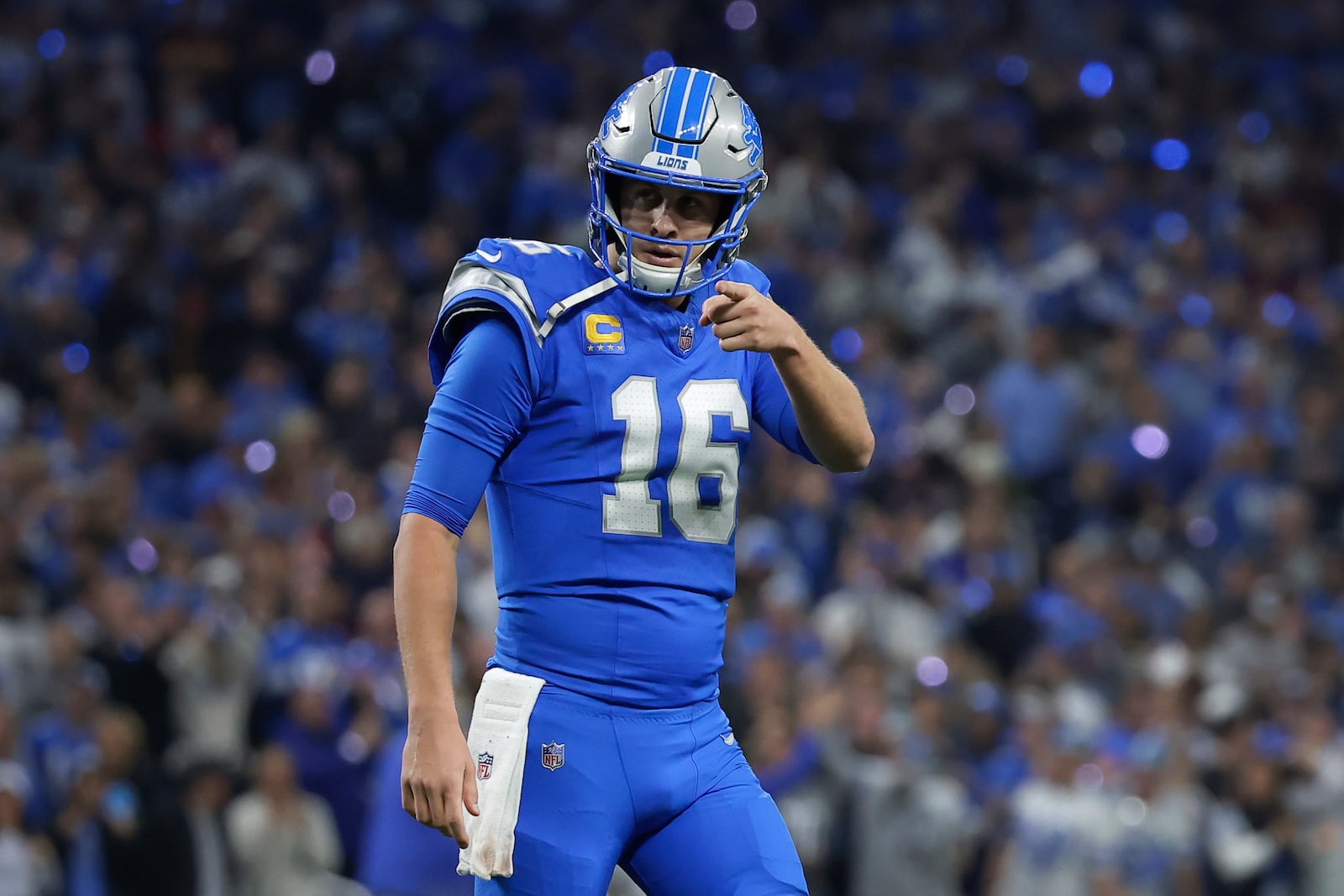 Detroit Lions quarterback Jared Goff (16) reacts to a two-yard touchdown pass to Sam LaPorta against the Washington Commanders during the first half of an NFL football divisional playoff game, Saturday, Jan. 18, 2025, in Detroit. (AP Photo/Rey Del Rio)