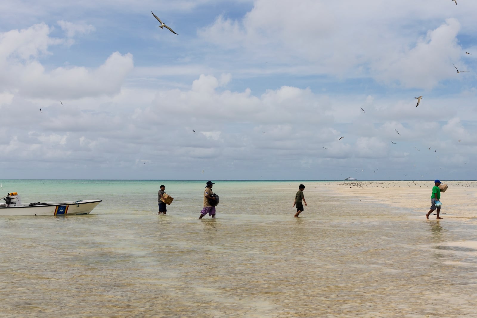 Metfidza Marino, from left, Tony Chayum, Mouwanes Patris Bismark and Aarson Aaron help the Hatohobei State Rangers bring goods from the speed boats to the ranger station and living quarters on Helen Island, Palau, July 17, 2024. (AP Photo/Yannick Peterhans)