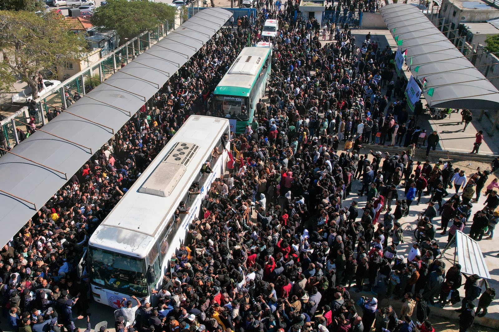 A crowd surrounds the buses carrying freed Palestinian prisoners as they a arrive in Khan Younis, Gaza Strip, Saturday, Feb. 15, 2025. (AP Photo/Mohammad Abu Samra)