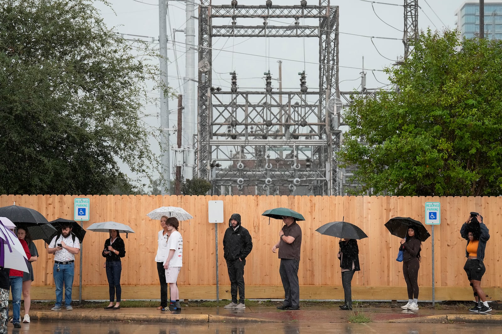 Rain pours down while voters are waiting in line to cast their vote on Election Day Tuesday, Nov. 5, 2024 at West Gray Multiservice Center in Houston. (Yi-Chin Lee/Houston Chronicle via AP)