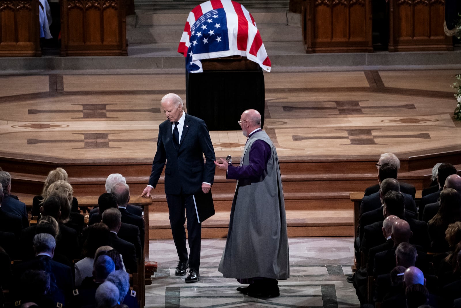 President Joe Biden walks to his seat after delivering remarks at the state funeral of former President Jimmy Carter at the National Cathedral, Thursday, Jan. 9, 2025, in Washington. (Haiyun Jiang/The New York Times via AP, Pool)