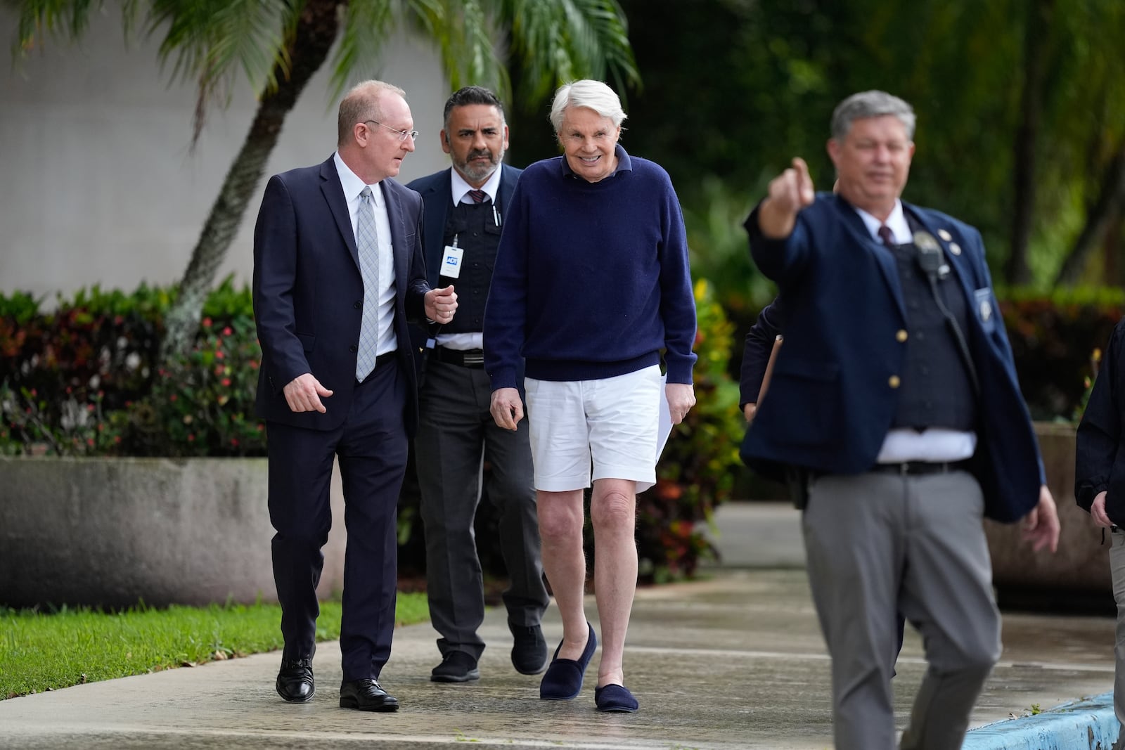 Michael Jeffries, center, former CEO of Abercrombie & Fitch, leaves with his attorney Brian Bieber, left, following a hearing at the Paul G. Rogers Federal Building and U.S. Courthouse in West Palm Beach, Fla., Tuesday, Oct. 22, 2024. (AP Photo/Rebecca Blackwell)