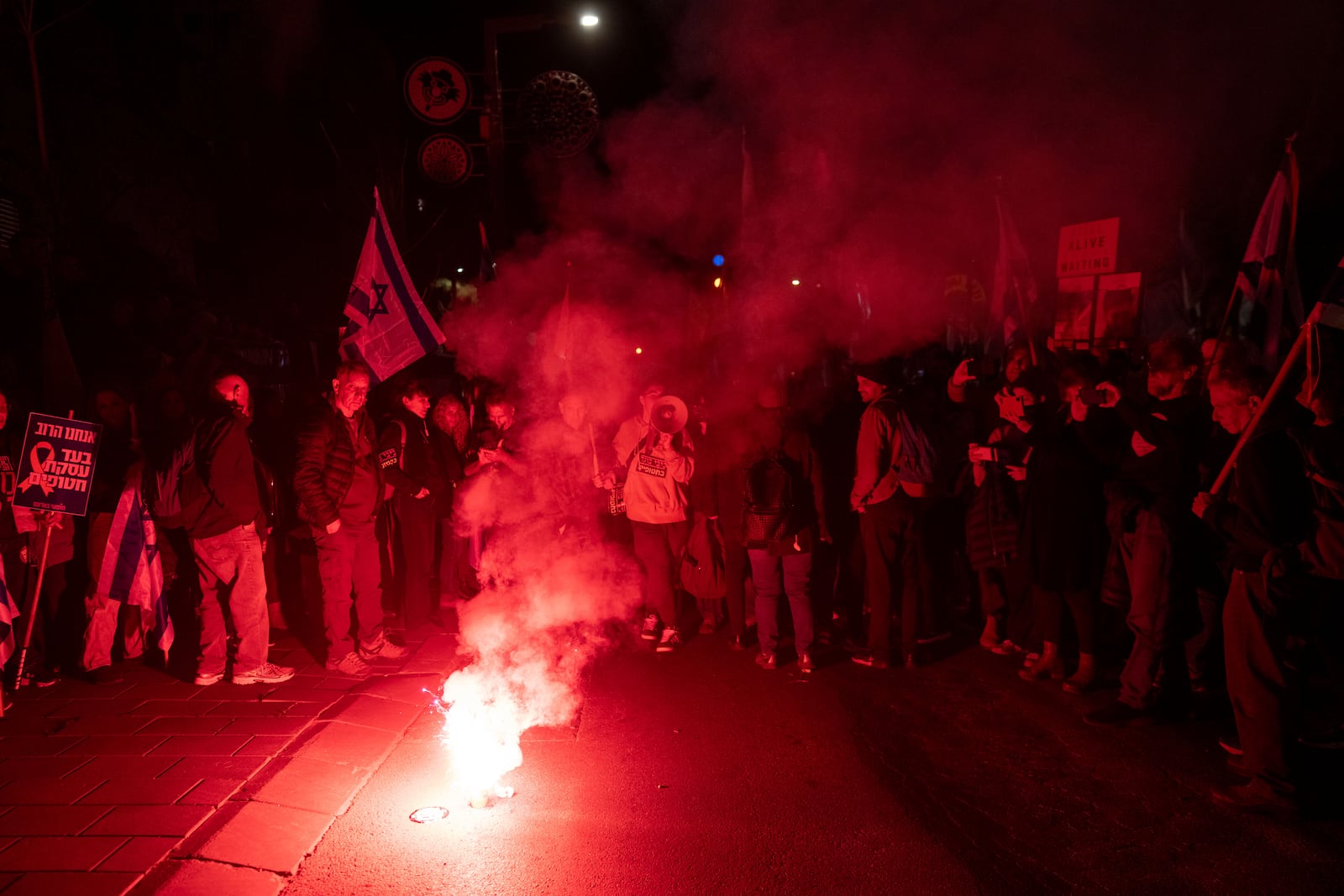 Israelis take part in a protest against Israeli Prime Minister Benjamin Netanyahu's government, and the release of the hostages held in the Gaza Strip by the Hamas militant group, in Jerusalem, Sunday, March 2, 2025. (AP Photo/Ohad Zwigenberg)