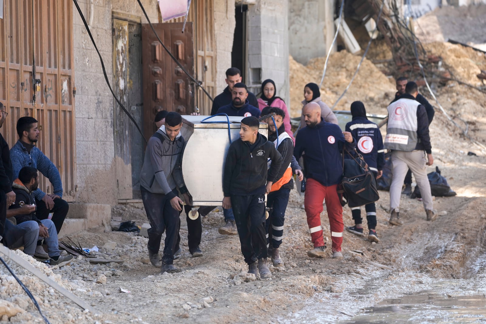 Residents of the West Bank urban refugee camp of Nur Shams evacuate their homes and carry their belongings as the Israeli military continues its operation in the area on Wednesday, Feb. 26, 2025. (AP Photo/Majdi Mohammed)