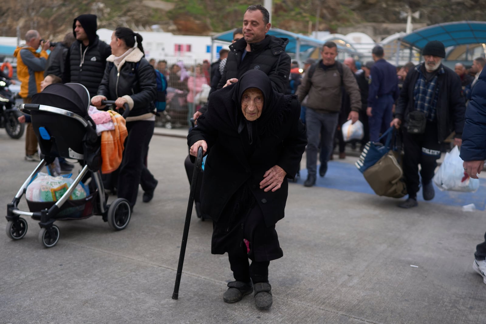 Flora, 94, said she survived a deadly earthquake on Santorini in 1956, as she boards a ferry bound for the Greek mainland, in the earthquake-struck Greek island, Tuesday, Feb. 4, 2025. (AP Photo/Petros Giannakouris)