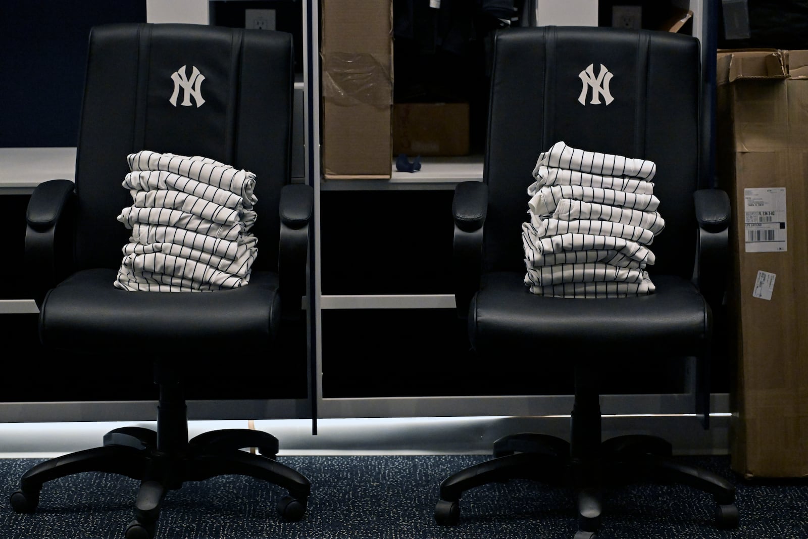 New York Yankees uniform pants are stacked on chairs near the players' lockers during a tour of the upgraded team spring training facilities Thursday, Feb. 13, 2025, at George M. Steinbrenner Field in Tampa, Fla. (AP Photo/Steve Nesius)