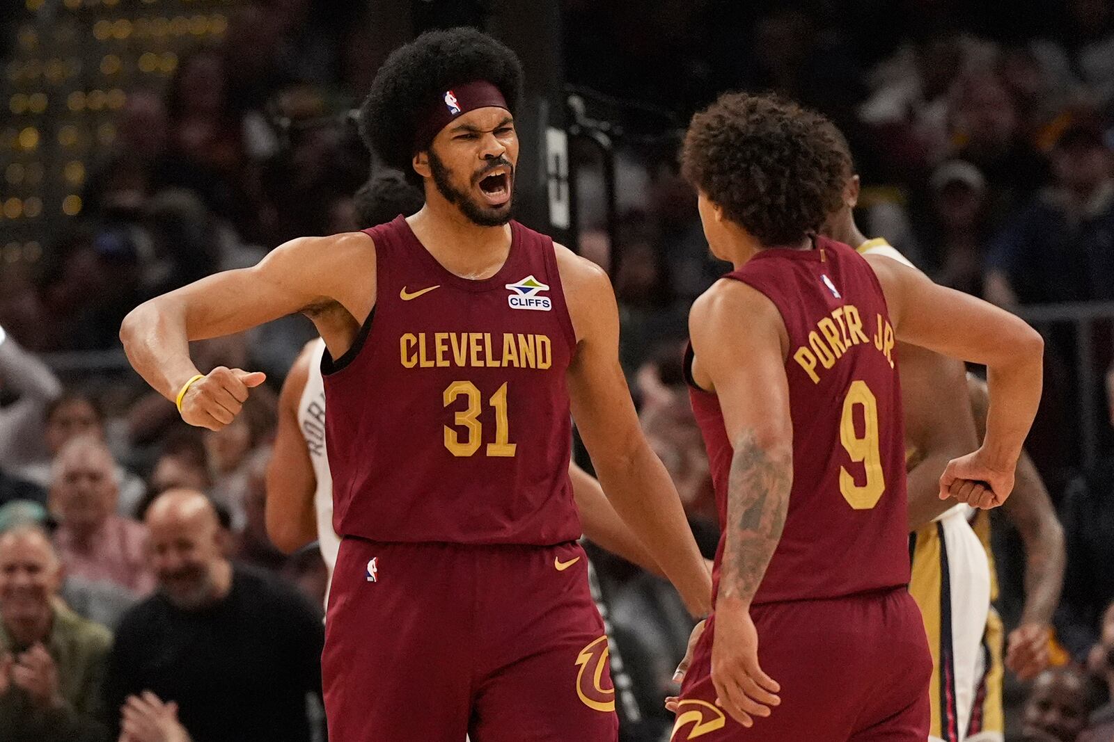 Cleveland Cavaliers center Jarrett Allen (31) celebrates a dunk with teammate Craig Porter Jr. (9) in the first half of an NBA basketball game against the New Orleans Pelicans, Wednesday, Nov. 20, 2024, in Cleveland. (AP Photo/Sue Ogrocki)