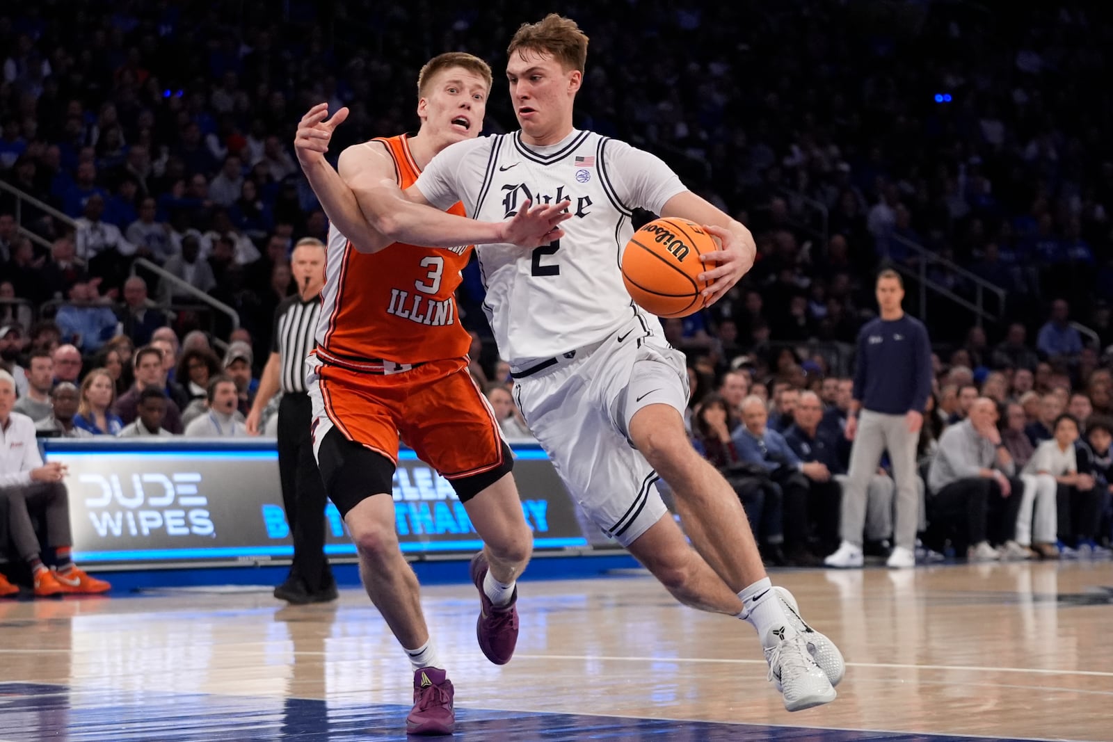 Duke's Cooper Flagg (2) drives past Illinois' Ben Humrichous (3) during the first half of an NCAA college basketball game Saturday, Feb. 22, 2025, in New York. (AP Photo/Frank Franklin II)