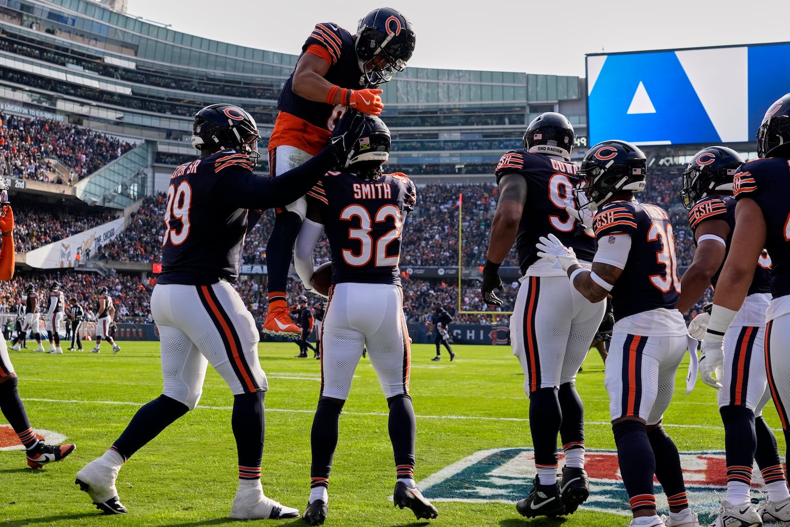 Chicago Bears' Kyler Gordon congratulates MarShawn Lloyd (32) after Lloyd's interception during the first half of an NFL football game against the Green Bay Packers Sunday, Nov. 17, 2024, in Chicago. (AP Photo/Nam Y. Huh)