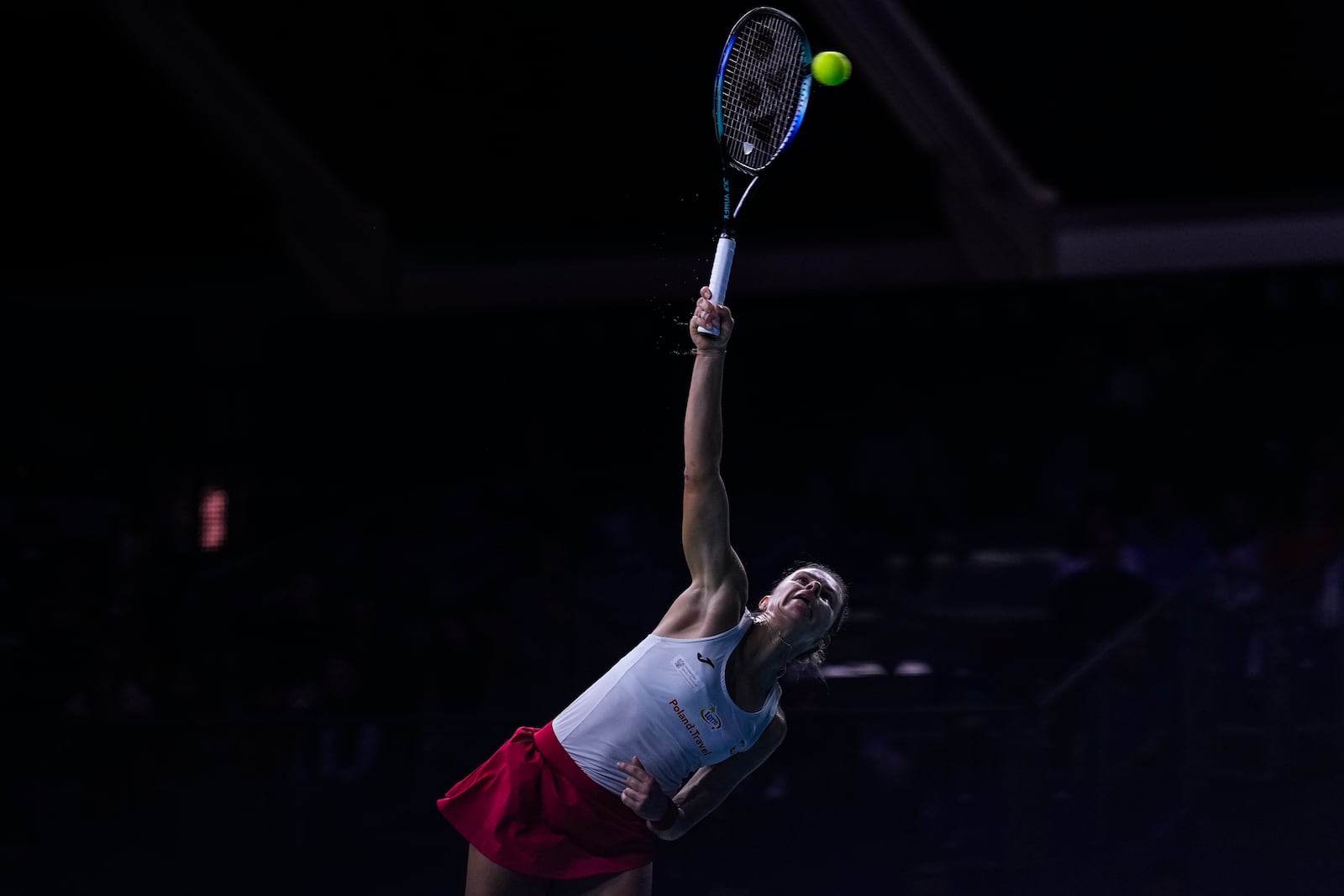 Poland's Magda Linette serves to Spain's Sara Sorriber Tormo during the Billie Jean King Cup Finals, at the Martin Carpena Sports Hall, in Malaga, southern Spain, on Friday, Nov. 15, 2024. (AP Photo/Manu Fernandez)