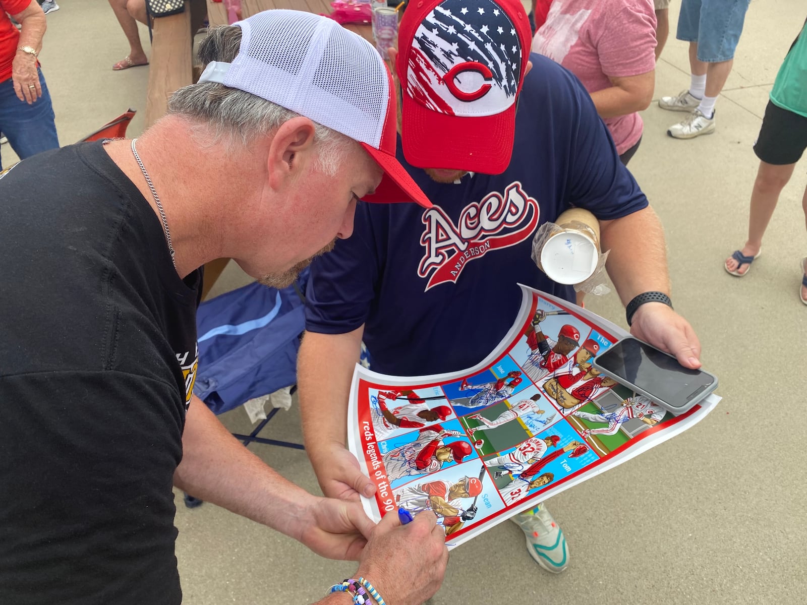 Sean Casey is the last autograph this Cincinnati Reds fan needed on this poster featuring Reds Legends of the ‘90s. Casey was at Joe Nuxhall Miracle League Fields on Saturday, July 23, 2022, with a group of players from his Miracle League of the South Hills in Pittsburgh. MICHAEL D. PITMAN/STAFF 