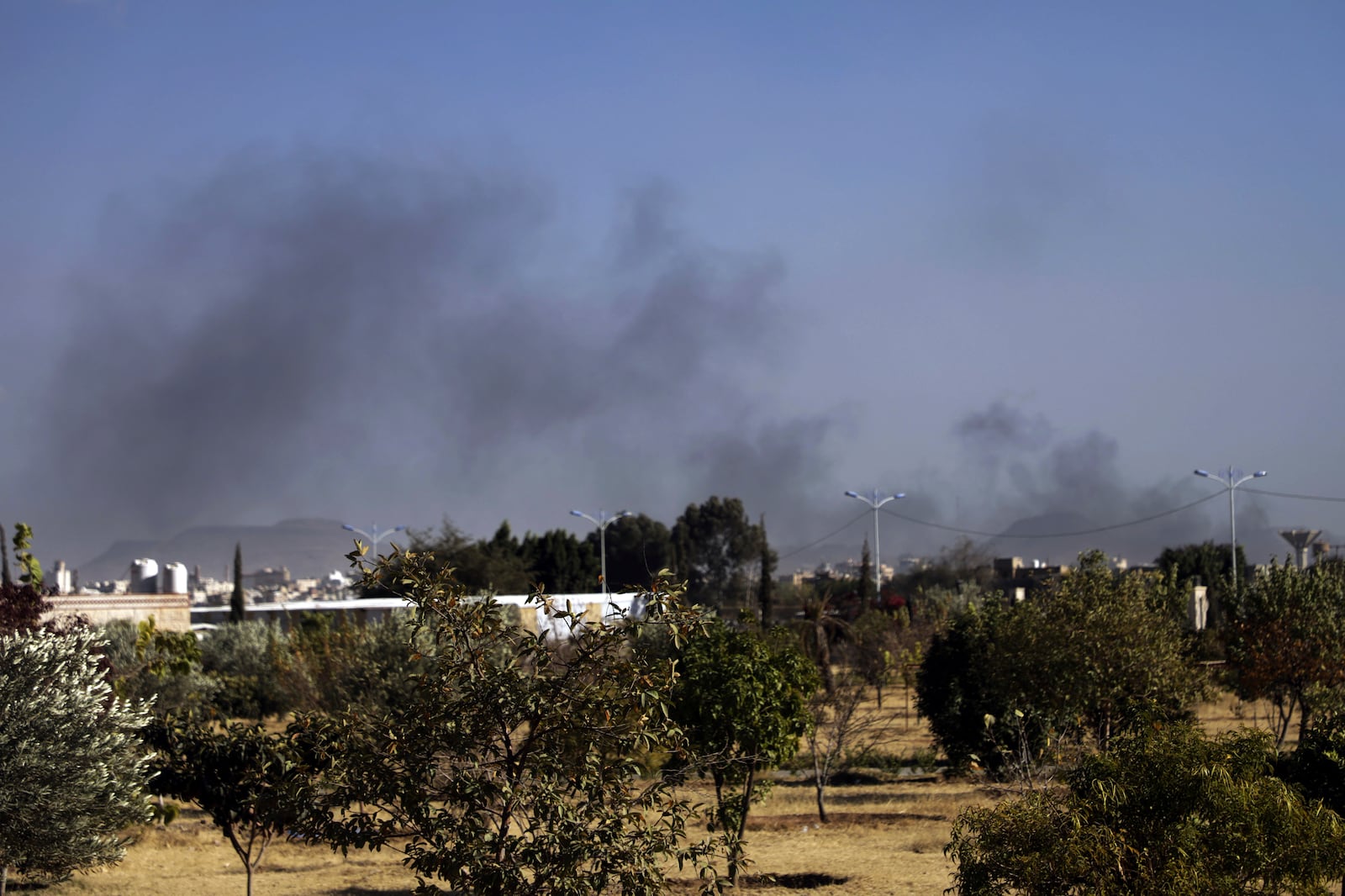 Black smoke raises following airstrikes on Sanaa, Yemen, Friday, Jan. 10, 2025. (AP Photo/Osamah Abdulrahman)