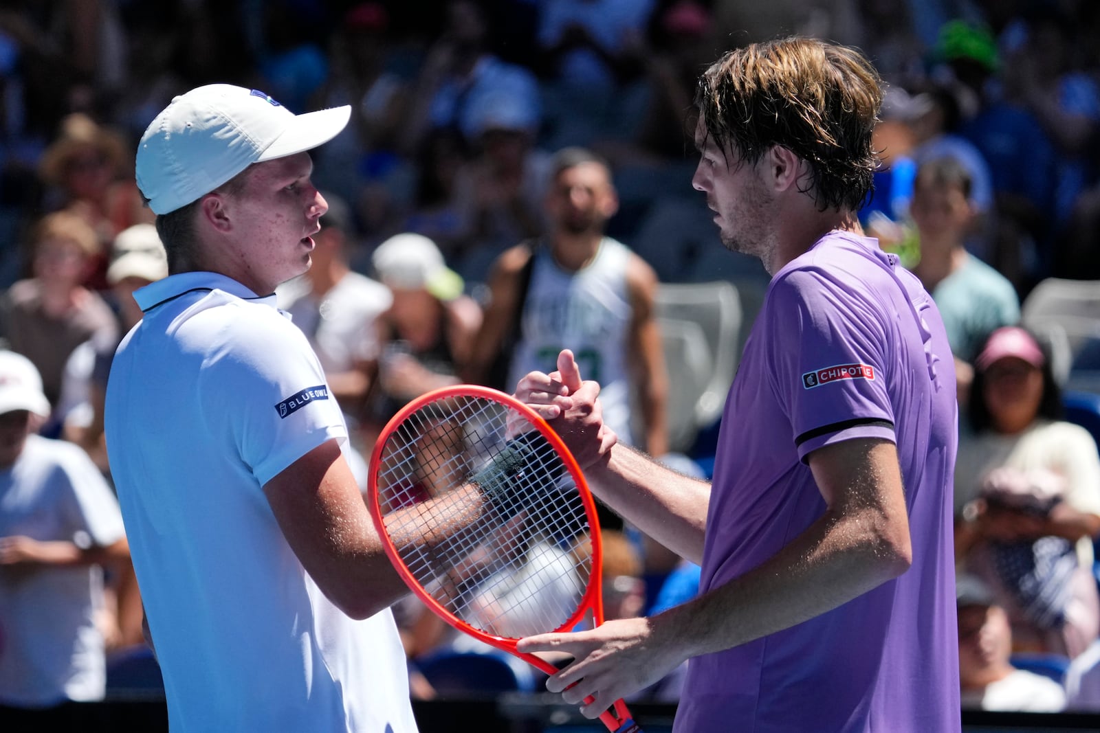 Taylor Fritz, right, of the U.S. is congratulated by compatriot Jenson Brooksby following their first round match at the Australian Open tennis championship in Melbourne, Australia, Tuesday, Jan. 14, 2025. (AP Photo/Vincent Thian)