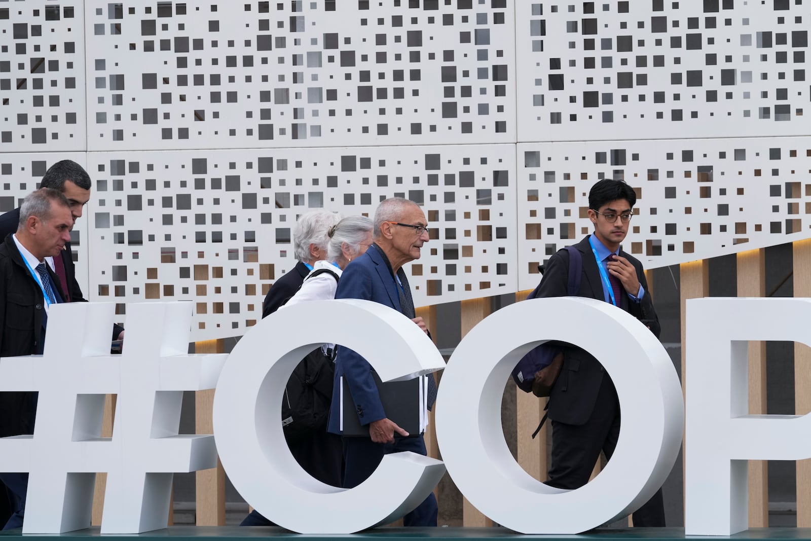 John Podesta, U.S. climate envoy, center right, and U.S. Deputy Climate Envoy Sue Biniaz, center, walk outside the venue for the COP29 U.N. Climate Summit, Saturday, Nov. 23, 2024, in Baku, Azerbaijan. (AP Photo/Sergei Grits)