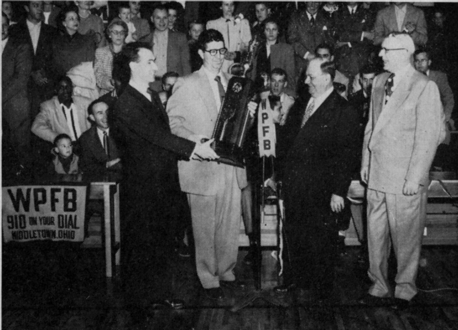 Longtime Middletown Journal Sports Editor Jerry Nardiello hands a state championship trophy to Coach Paul Walker as Wade E. Miller watches. CONTRIBUTED