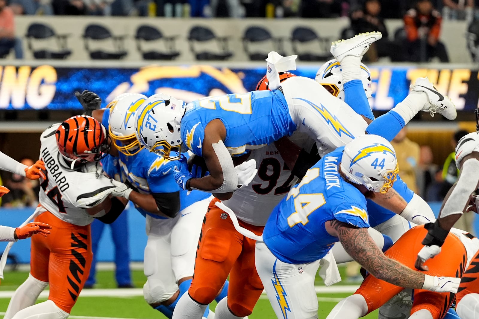 Los Angeles Chargers running back J.K. Dobbins (27) leaps into the end zone to score a rushing touchdown during the first half of an NFL football game against the Cincinnati Bengals, Sunday, Nov. 17, 2024, in Inglewood, Calif. (AP Photo/Gregory Bull)