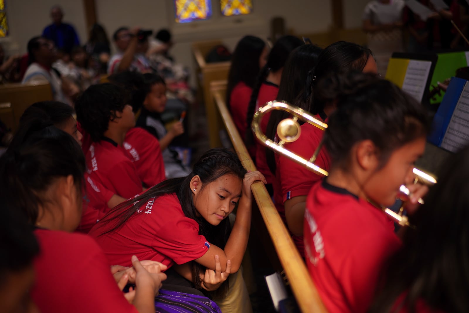 Young parishioners sit together during a Karen-language service at Indian Lake Baptist Church, while celebrating 15 years of partnership with the 150-year-old congregation founded by Swedish immigrants, in Worthington, Minn., on Sunday Oct. 20, 2024. (AP Photo/Jessie Wardarski)