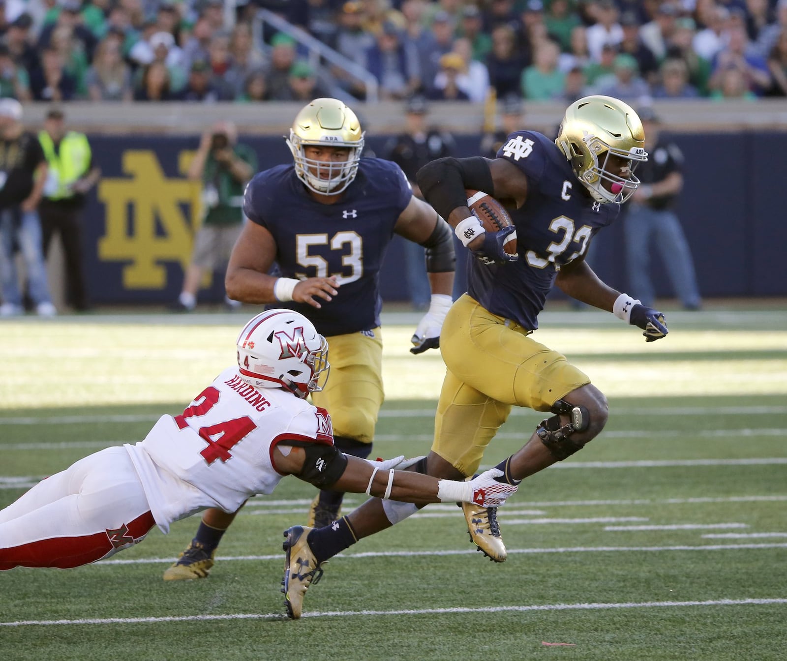 Notre Dame running back Josh Adams (33) gets away from Miami cornerback Heath Harding as he heads for the end zone during Saturday night’s 52-17 Fighting Irish victory at Notre Dame Stadium in Notre Dame, Ind. CHARLES REX ARBOGAST/ASSOCIATED PRESS