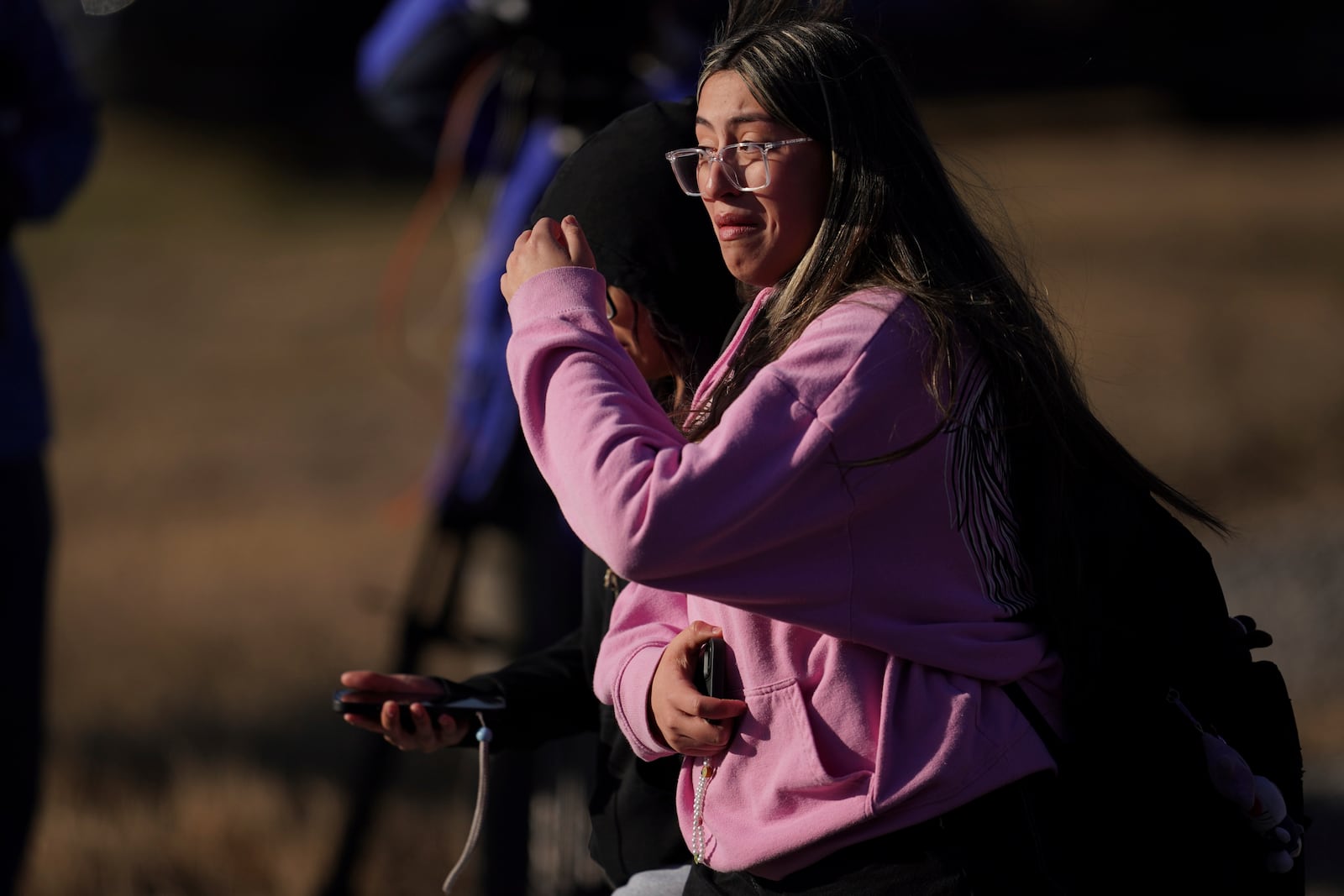 A student walks from the Antioch High School after a shooting in Nashville, Tenn., Wednesday, Jan. 22, 2025. (AP Photo/George Walker IV)