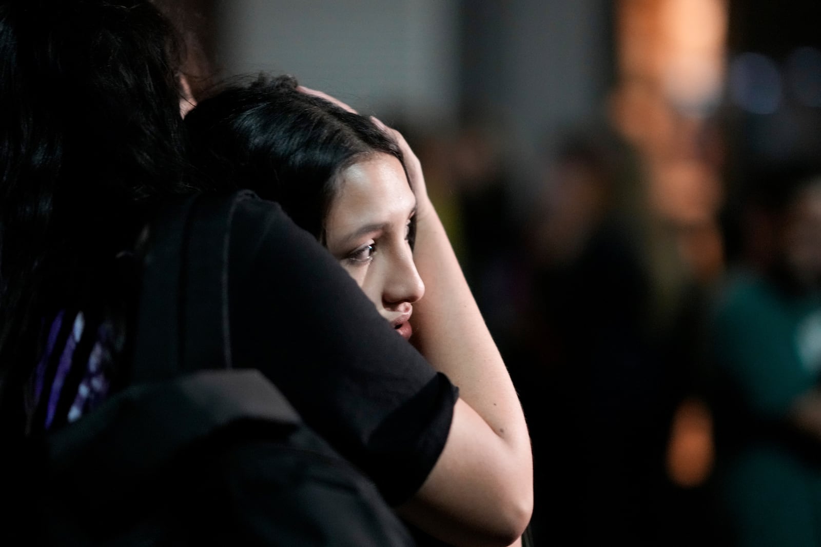 Bystanders embrace outside the hotel where former One Direction singer Liam Payne was found dead after he fell from a balcony in Buenos Aires, Argentina, Wednesday, Oct. 16, 2024. (AP Photo/Natacha Pisarenko)