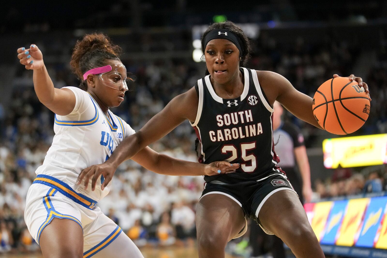 South Carolina guard Raven Johnson (25) dribbles against UCLA guard Londynn Jones (3) during the first half of an NCAA college basketball game, Sunday, Nov. 24, 2024, in Los Angeles. (AP Photo/Eric Thayer)