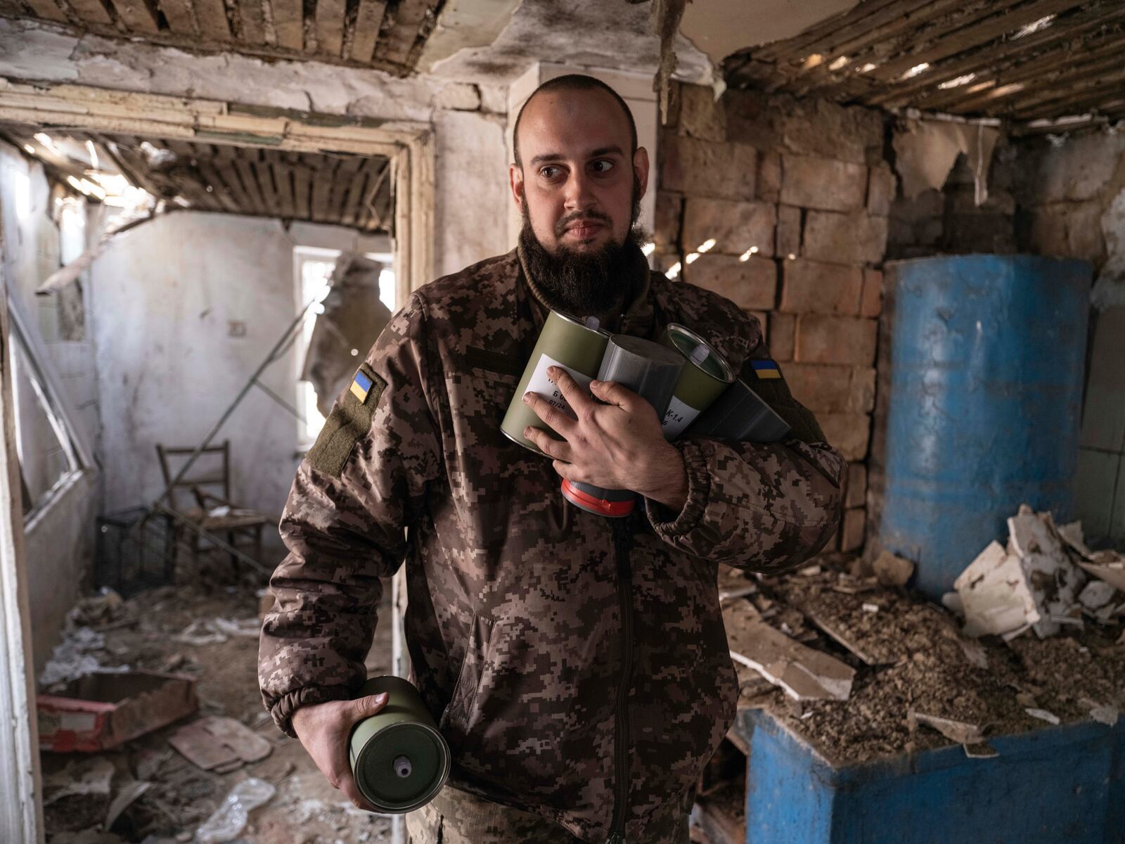 In this photo provided by Ukraine's 93rd Kholodnyi Yar Separate Mechanized Brigade press service, a soldier carries bombs for FPV drones in a shelter in Kramatorsk direction, Donetsk region, Ukraine, Saturday, March 22, 2025. (Iryna Rybakova/Ukraine's 93rd Mechanized Brigade via AP)