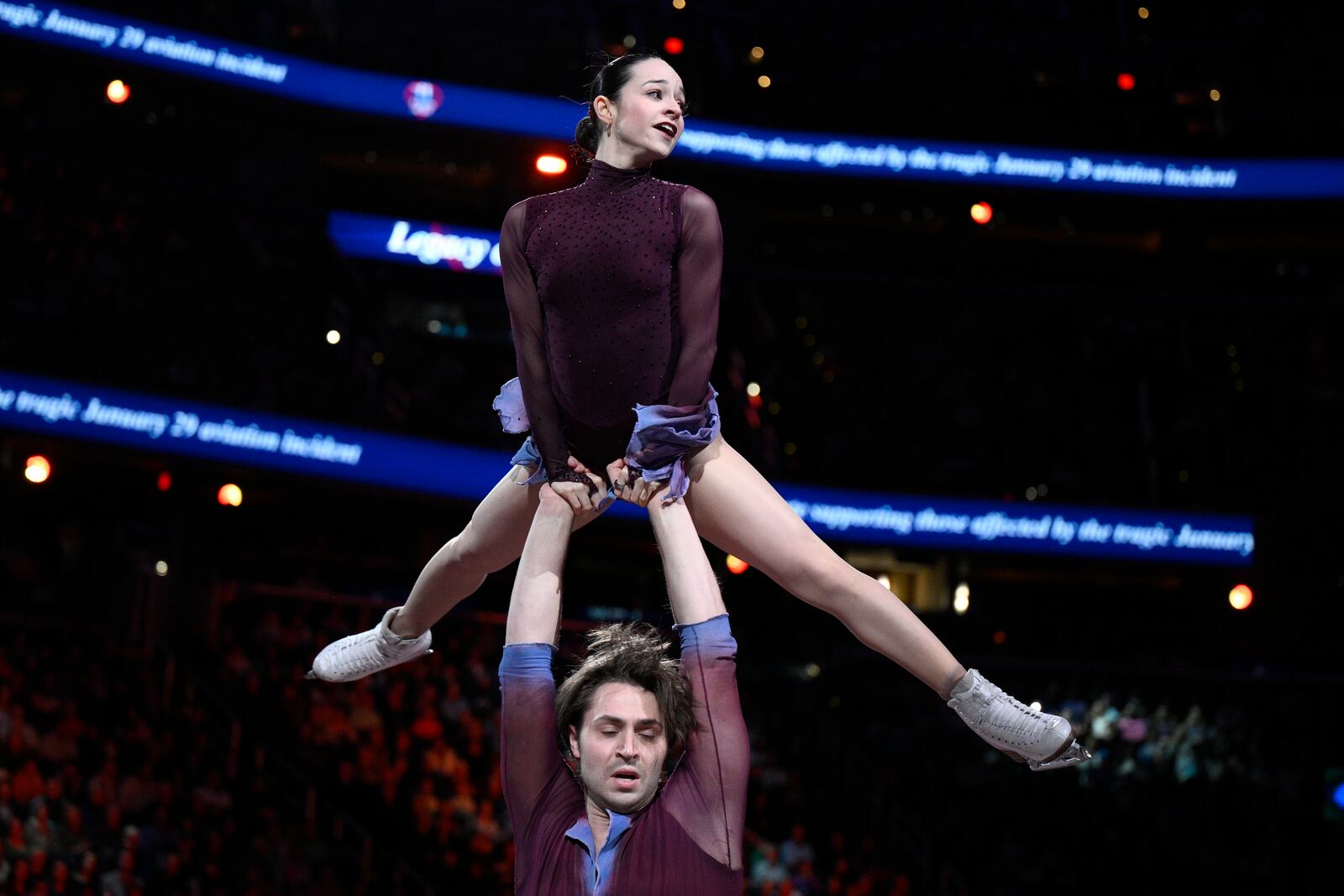 Katie McBeath, top, and Daniil Parkman perform Sunday, March 2, 2025, in Washington, at the Legacy on Ice event, a figure skating tribute to support the families and loved ones affected by the Jan. 29 aviation incident. (AP Photo/Nick Wass)