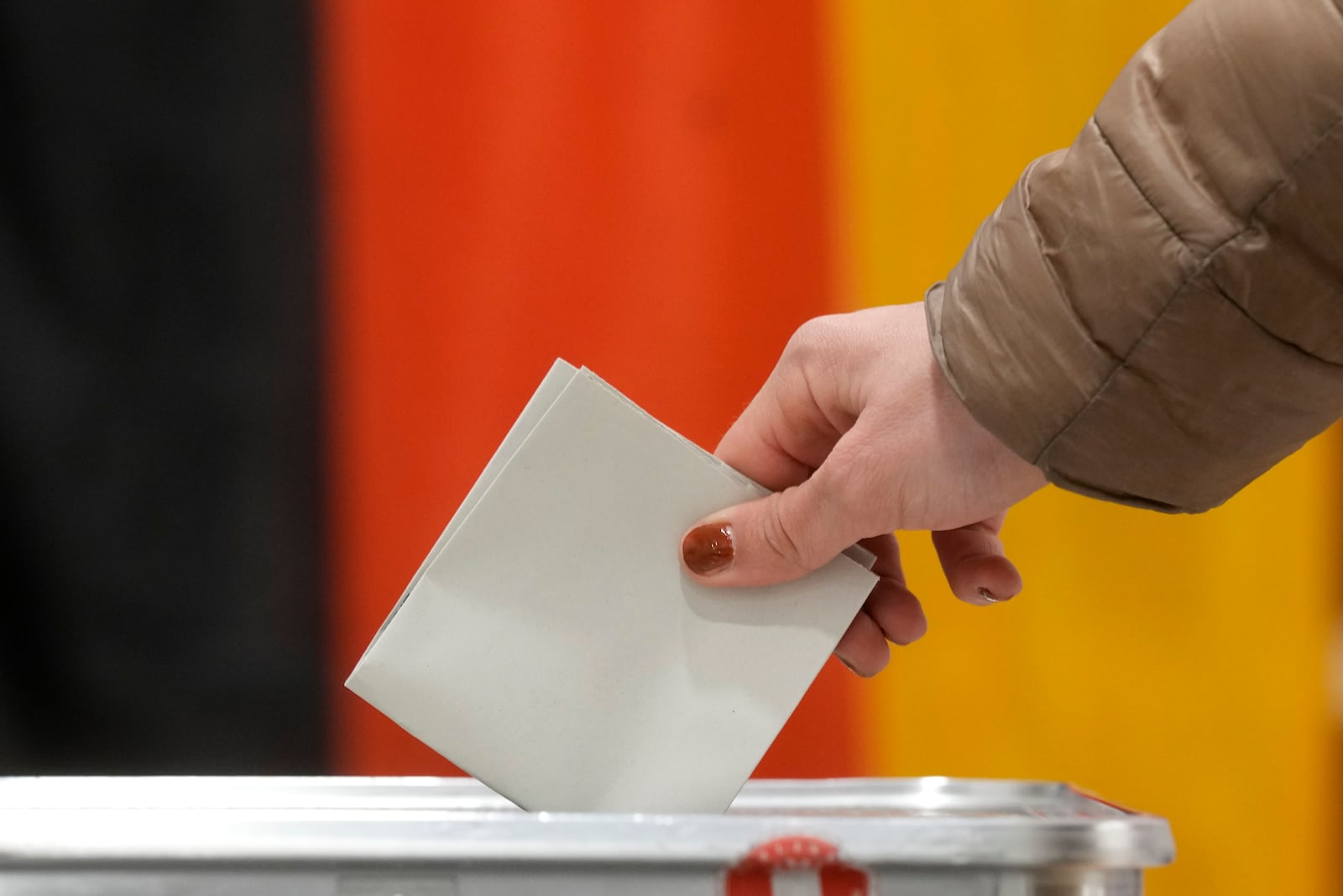 A resident casts a vote at a polling station in Berlin, Germany, Sunday, Feb. 23, 2025, during the German national election. (AP Photo/Michael Probst)