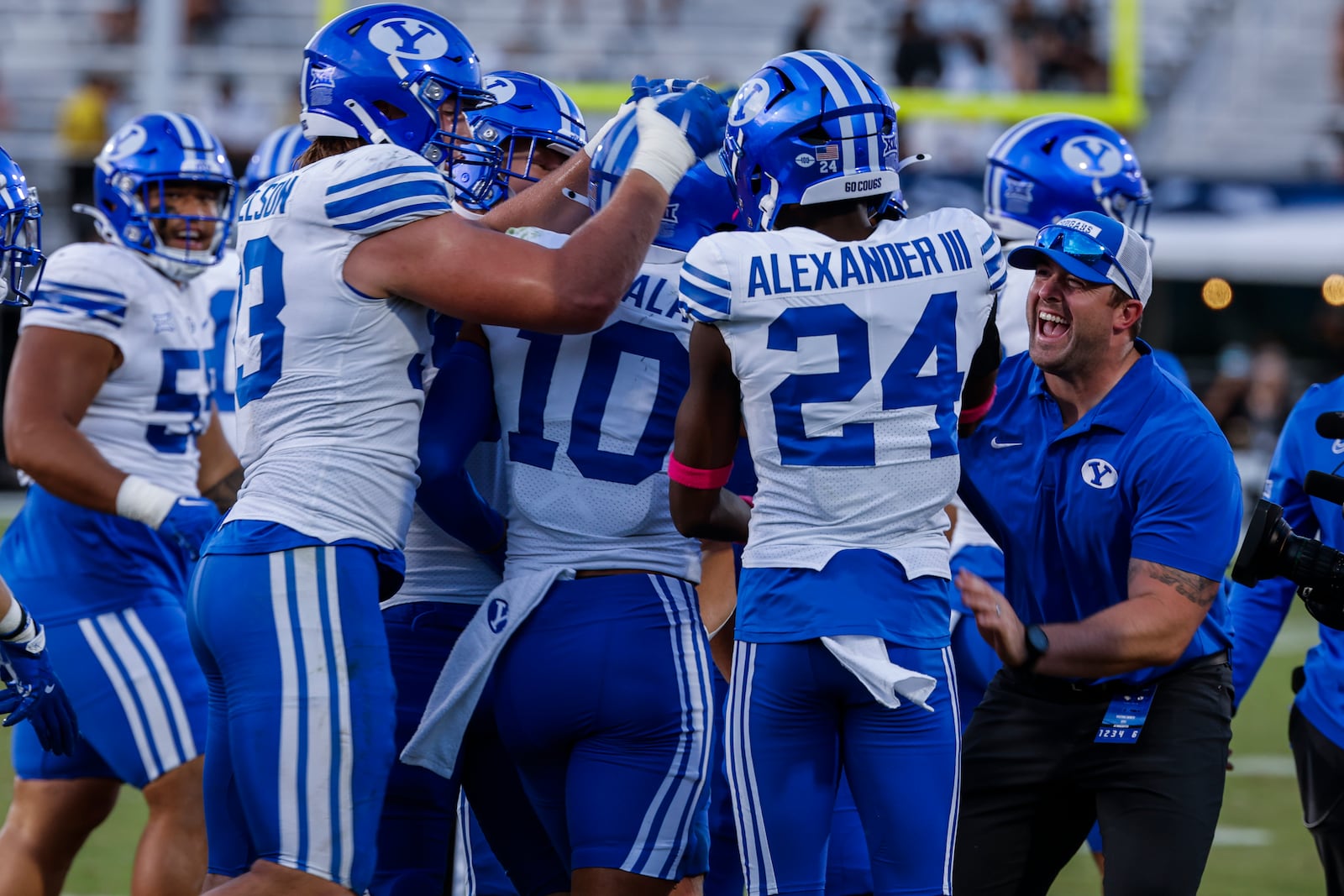 BYU safety Faletau Satuala (10) is swarmed by teammates after interception against Central Florida during the second half of an NCAA college football game, Saturday, Oct. 26, 2024, in Orlando, Fla. (AP Photo/Kevin Kolczynski)