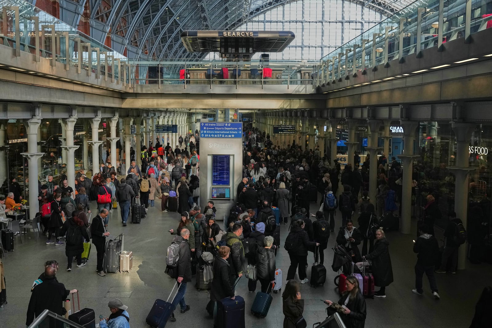 Passengers queue and wait near departures for Eurostar services at St Pancras International station in London, Friday March 7, 2025, after Eurostar trains to the capital have been halted following the discovery of an unexploded Second World War bomb near the tracks in Paris. (AP Photo/Frank Augstein)