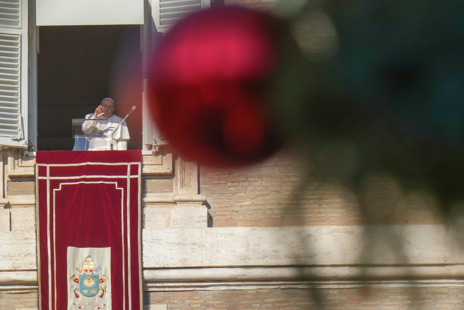 Pope Francis appears at his studio's window overlooking St. Peter's Square at The Vatican to bless pilgrims and faithful after presiding over a mass in St. Peter's Basilica on New Year's Day, Wednesday, Jan. 1, 2025. (AP Photo/Andrew Medichini)