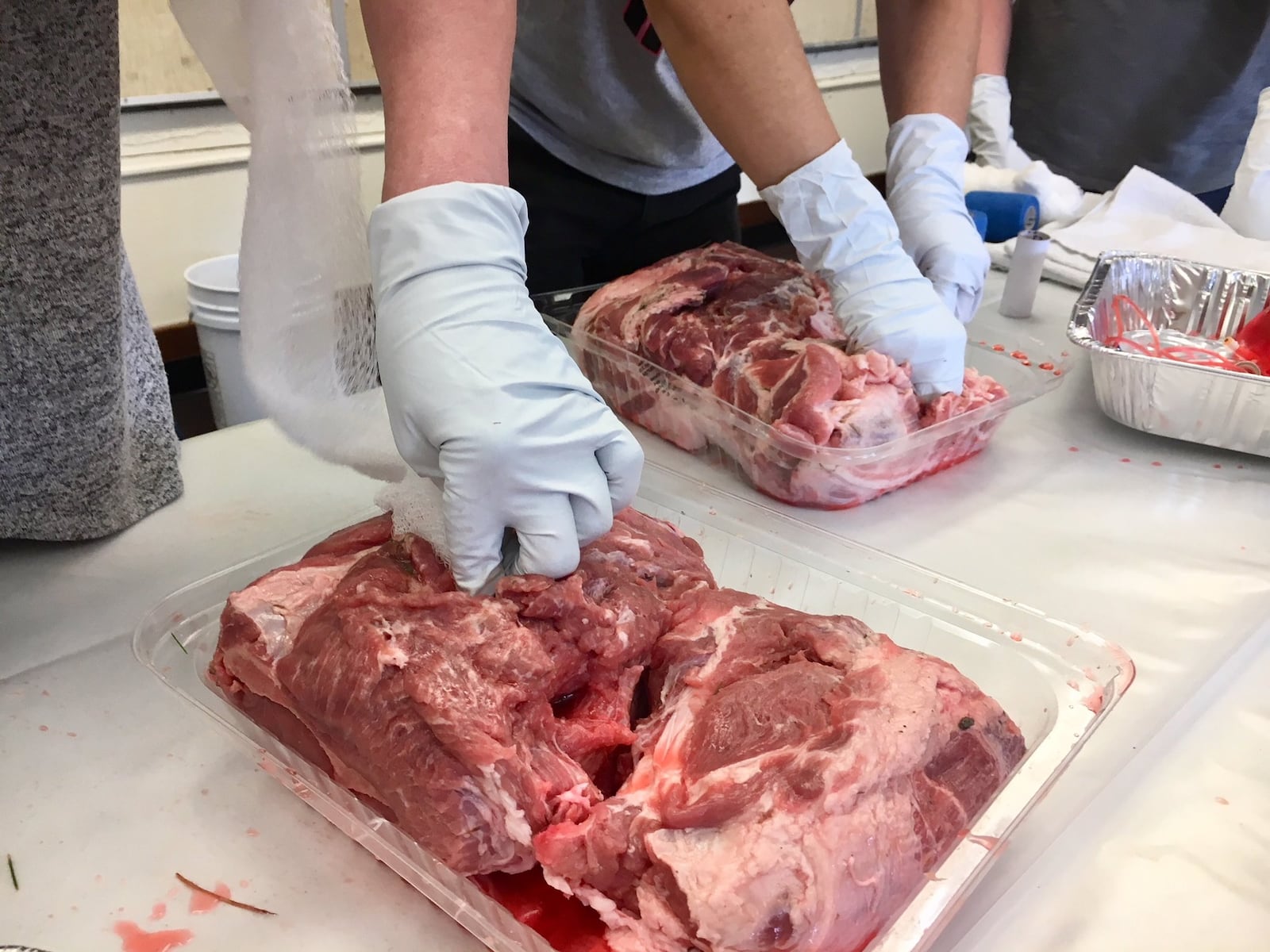 Ross Schools teachers and administrators thrust medical gauze into holes in beef as part of their first-ever training in emergency casualty care. The new large wound training this week in the Butler County school system will help school staffers stop bleeding from gaping wounds in the aftermath of a school shooting. 