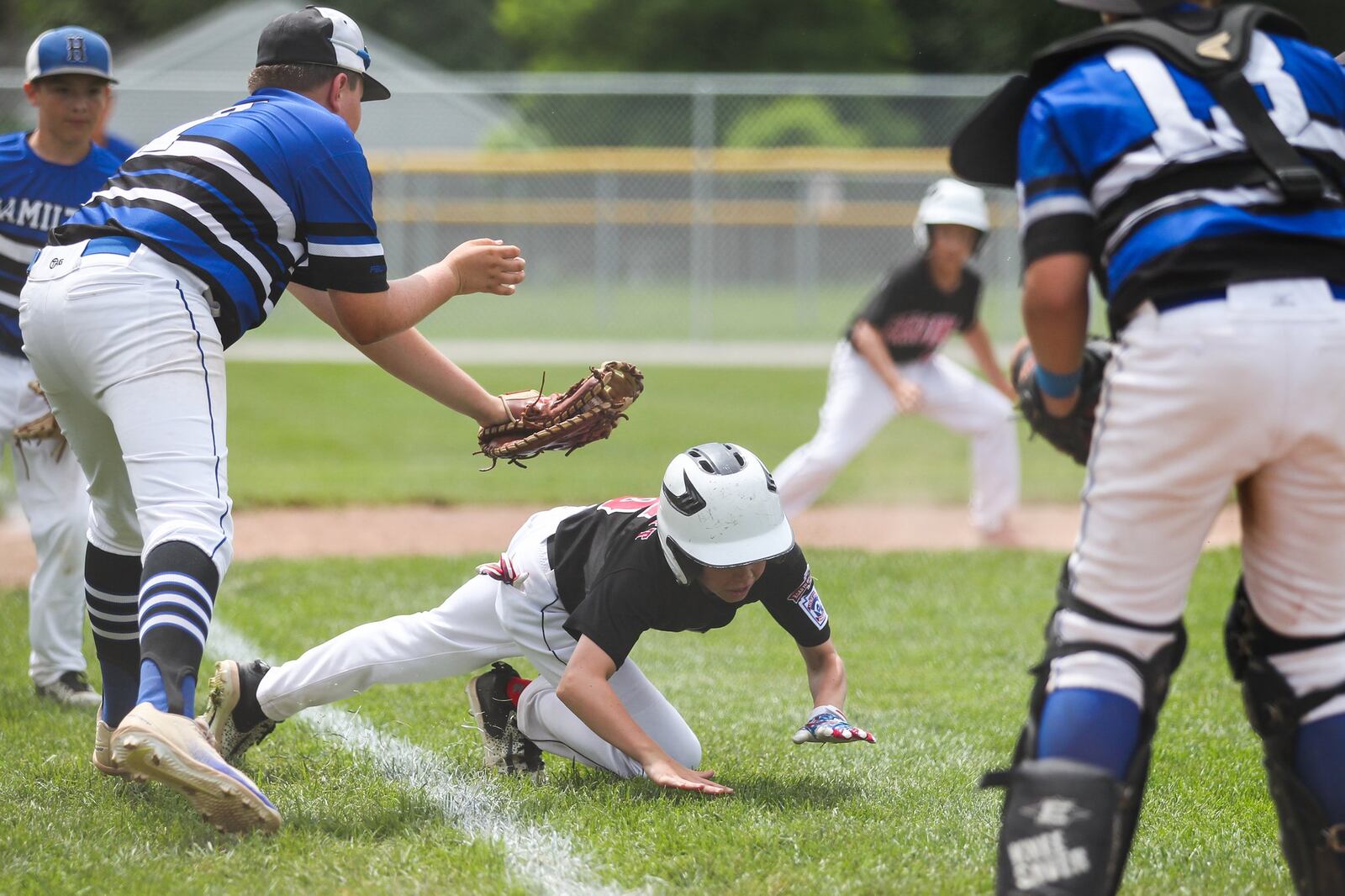 Hamilton West Side’s Casey Parsons is about to tag Canfield’s Connor Daggett for the final out Thursday during the winners’ bracket final of the Ohio Little League 12-year-old baseball tournament at Ford Park in Maumee. CONTRIBUTED PHOTO BY SCOTT GRAU