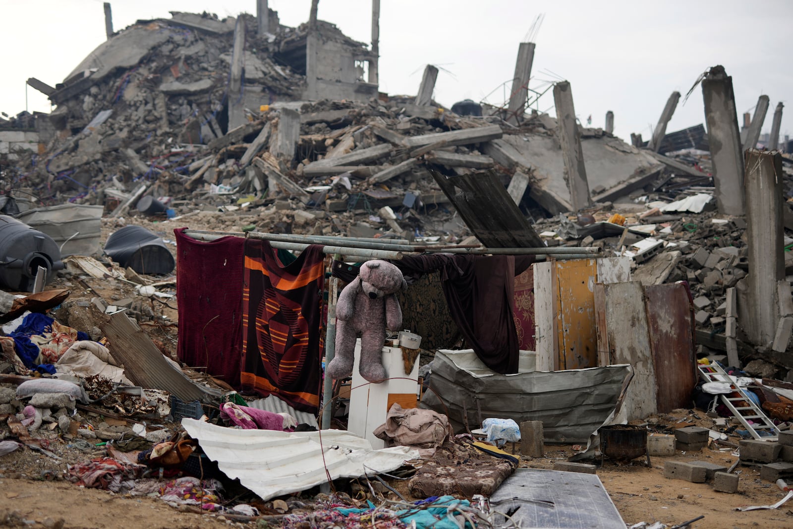 The Rehan family's encampment in the ruins of their home amid widespread destruction caused by the Israeli military's ground and air offensive in Jabaliya, Gaza Strip, Monday, Feb. 10, 2025. (AP Photo/Abdel Kareem Hana)