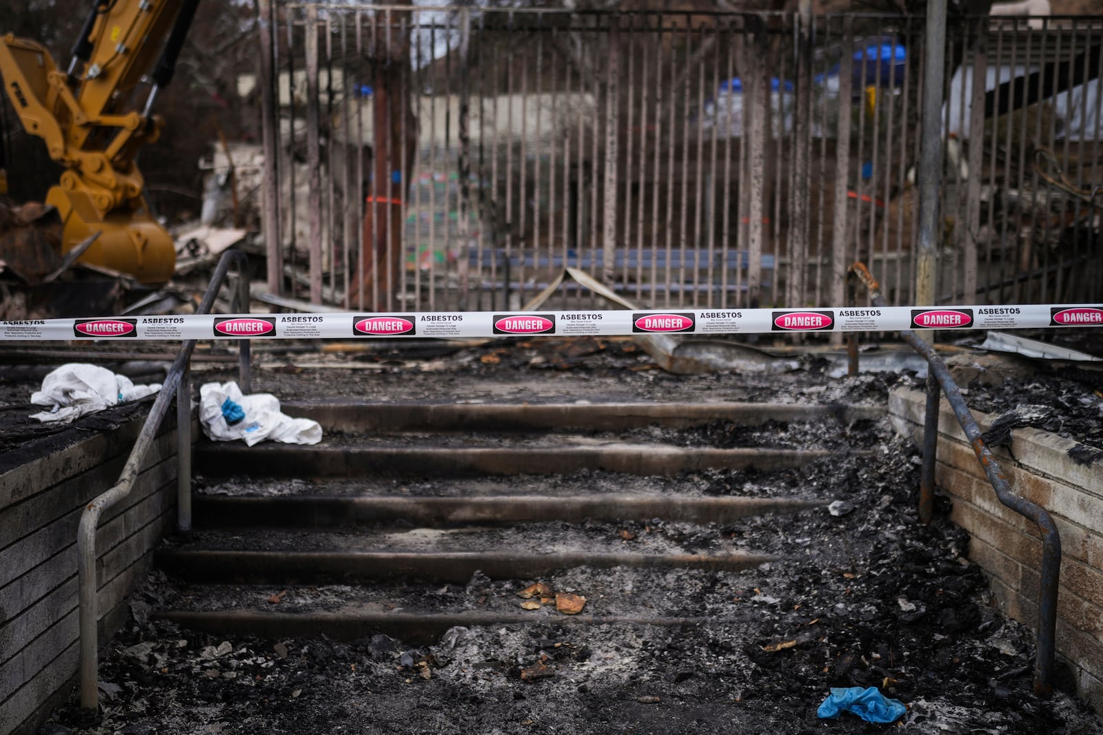 Caution tape blocks the charred entrance of Ceiba Phillips' school devastated by the Eaton Fire in Altadena, Calif., Wednesday, Feb. 5, 2025. (AP Photo/Jae C. Hong)