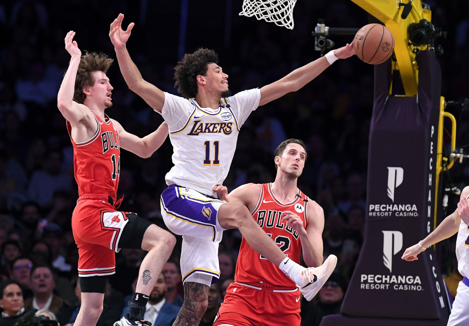 Los Angeles Lakers center Jaxson Hayes (11) battles for a rebound with Chicago Bulls forwards Matas Buzelis, left, and Zach Collins, third from left, in the first half of an NBA basketball game Saturday, March 22, 2025, in Los Angeles. (AP Photo/Wally Skalij)