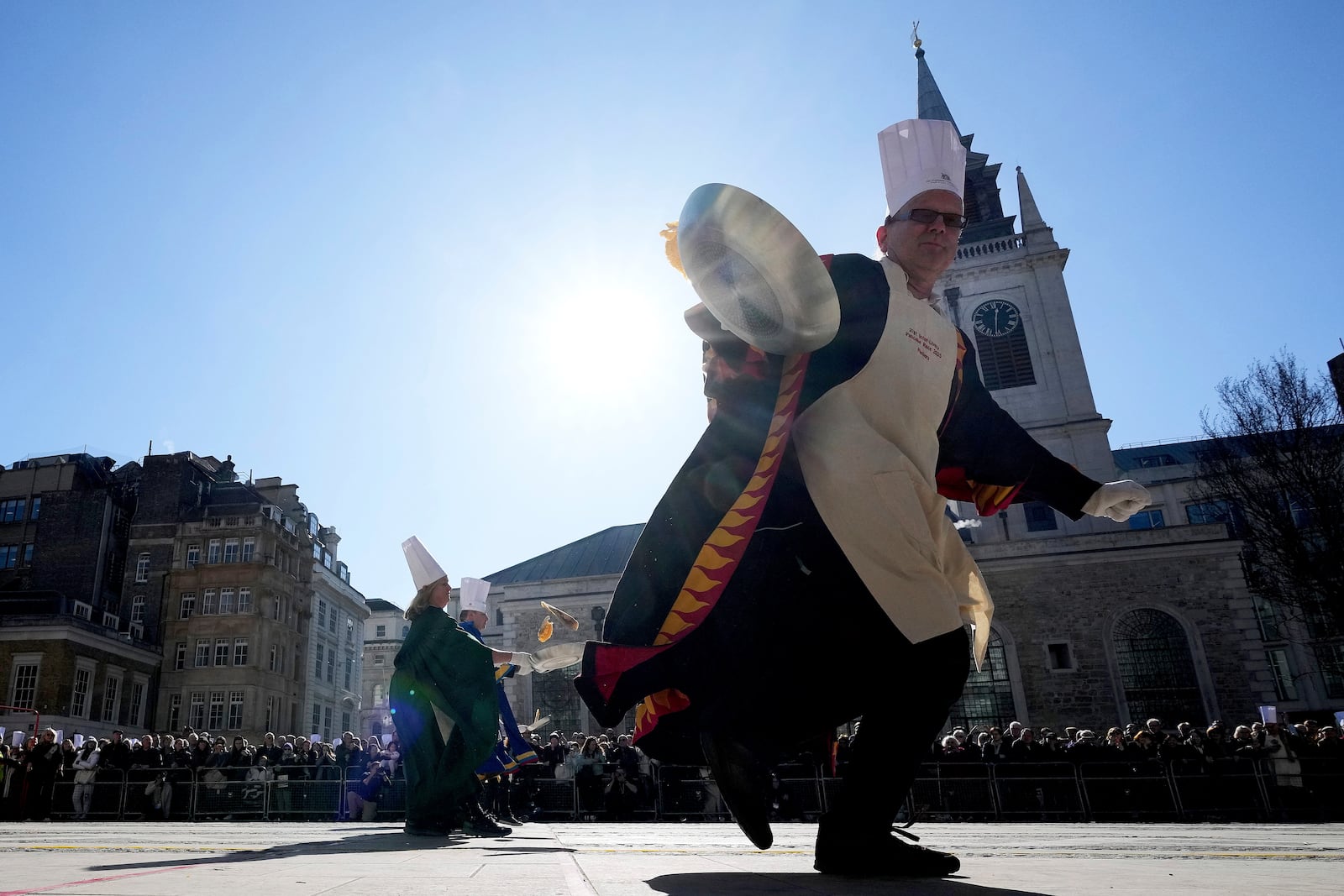 Runners compete during a traditional pancake race by livery companies at the Guildhall in London, Tuesday, March 4, 2025.(AP Photo/Frank Augstein)