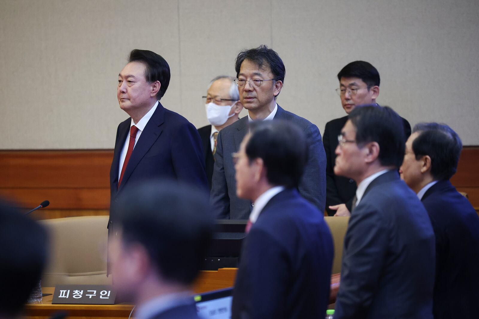 Impeached South Korean President Yoon Suk Yeol, left, stands for his impeachment trial at the Constitutional Court in Seoul, South Korea, Tuesday, Jan. 21, 2025. (Kim Hong-Ji/Pool Photo via AP)