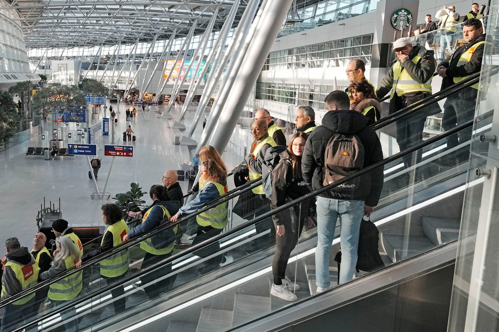 Airport workers protest during a strike of the union ver.di at the airport in Duesseldorf, Germany on Monday, March 10, 2025, when all major airports in Germany went on a warning strike. (AP Photo/Martin Meissner)